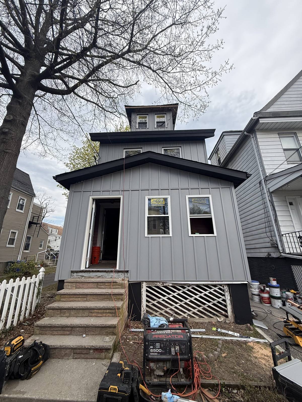 Completed renovation, modern gray facade with new front steps