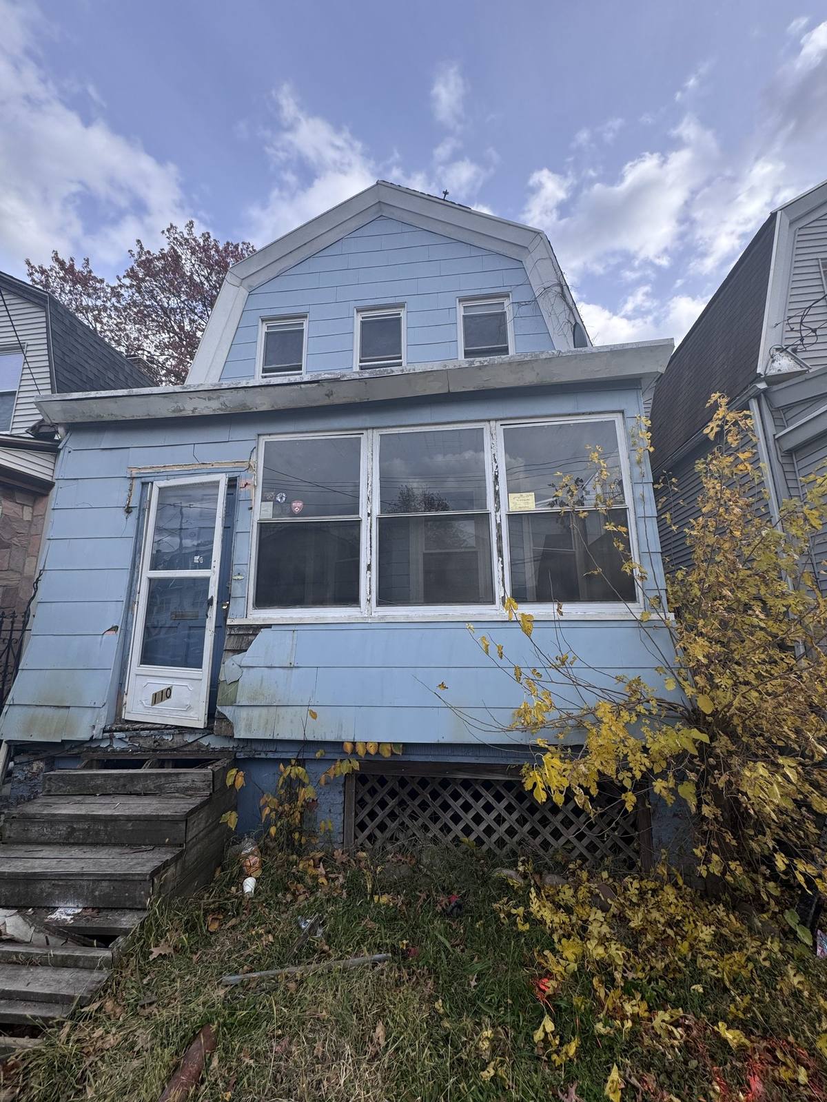 Vacant home before renovation, original blue siding